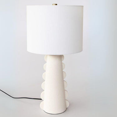 Scalloped ceramic table lamp with white matte finish showing distinctive curved side design and textured ceramic surface