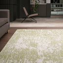 Geometric green and ivory area rug in a living room, enhancing the space with style.