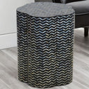 Small side table next to a couch, styled in a living room setting