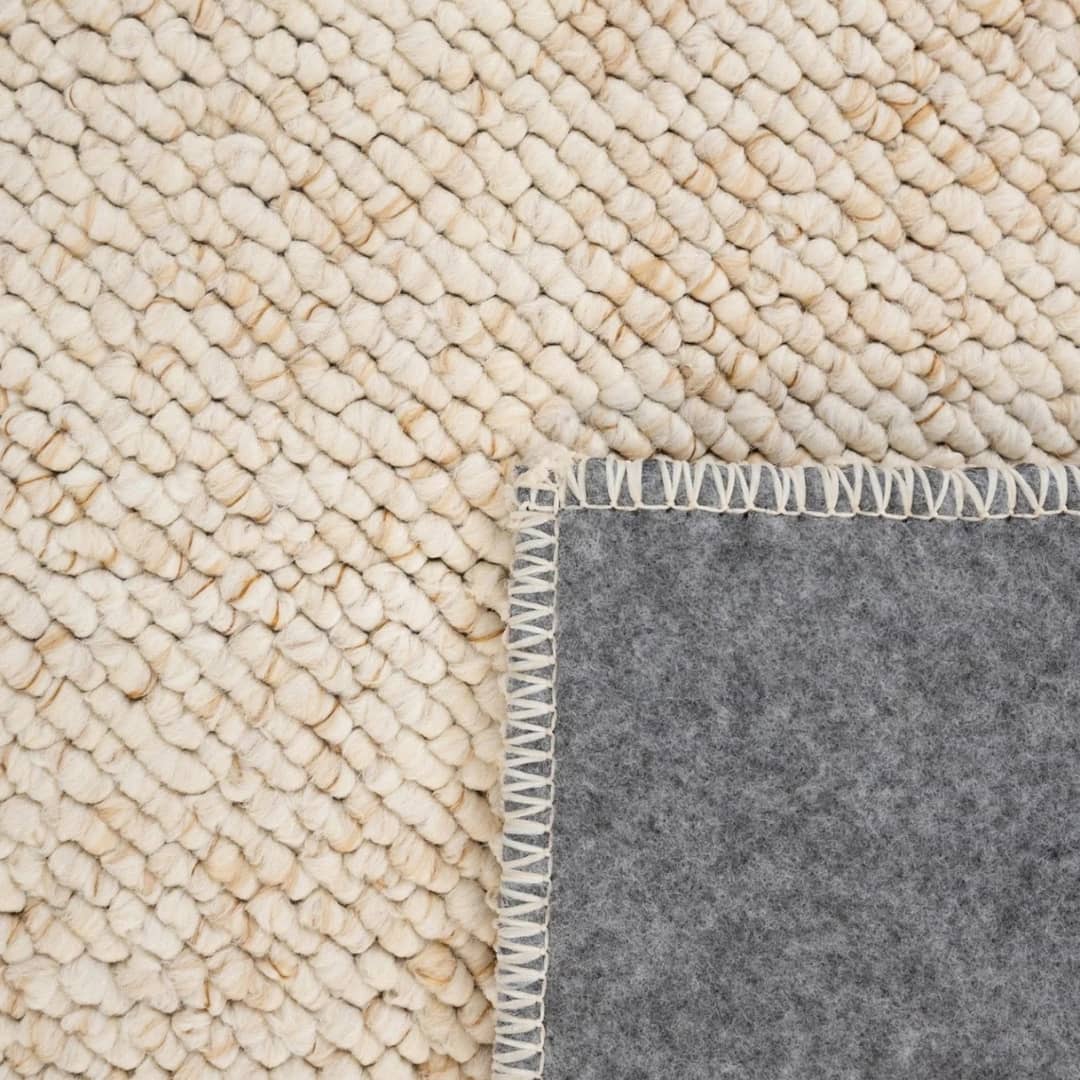 Close-up of thick woven texture on plush cosy rug