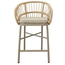 Lola counter stool in Corfu Dune with rattan weave, black powder-coated aluminium frame, and cushioned seat for indoor-outdoor use.