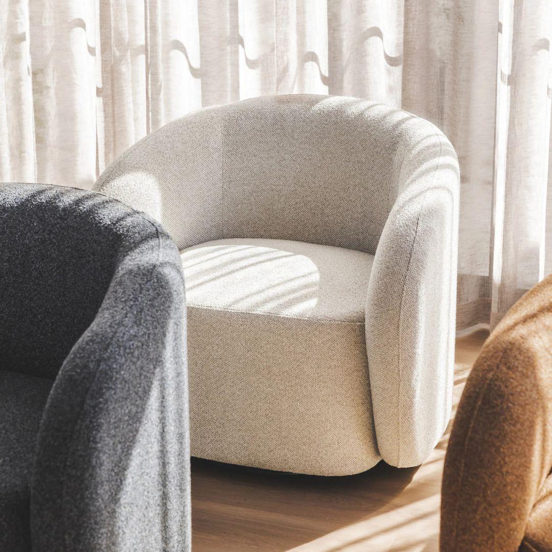 Emily Swivel Chair featured in a stylish living room, showcasing its function as a contemporary swivel armchair in Hertex Comet fabric.