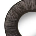 Round wall mirror with black natural fiber jute frame.