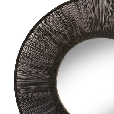 Round wall mirror with black natural fiber jute frame.