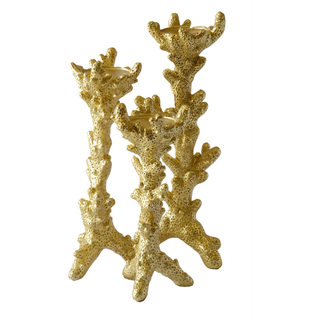 Elegant gold candle holders with textured coral detailing.