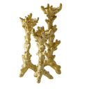 Elegant gold candle holders with textured coral detailing.