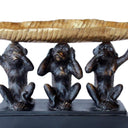 close-up of three wise monkeys design with metallic gold bowl
