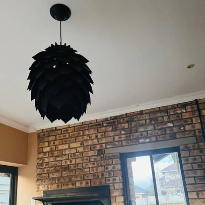 black pendant light from Woodka Interiors, styled in a outdoor area.