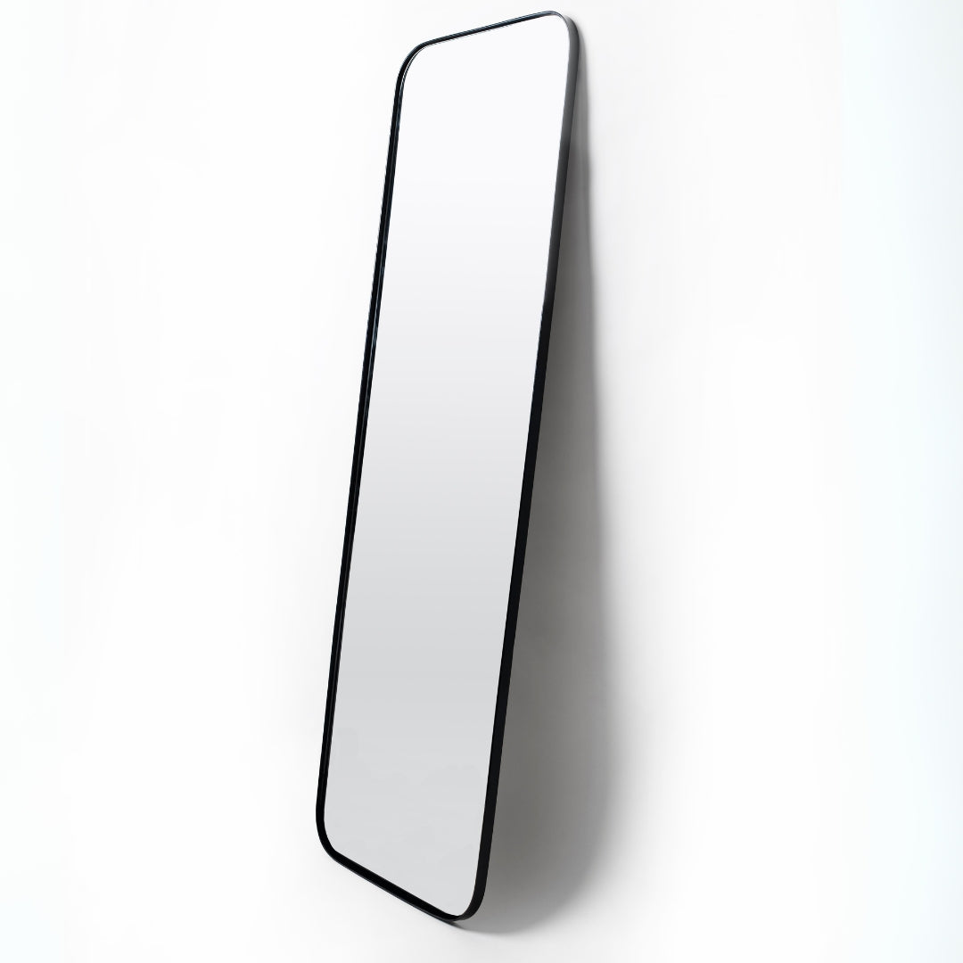 Black full-length mirror with rounded rectangular corners, matte steel frame, 180cm x 60cm, leaning or mounted.