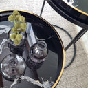 Top view of nesting side tables showing marble-effect tray styled with small vases