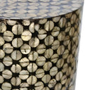 Close-up of black and gold circular pattern on mother-of-pearl accent table