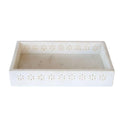 Close-up of delicate cutout detail on decorative marble tray