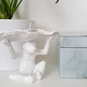 Unique monkey-shaped candle holder for tealight candles, compact decorative sculpture for home décor.