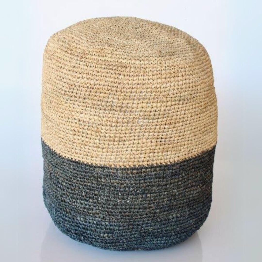 Lightweight natural and black pouf perfect as a footrest or seat.