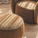 Nigella Ottoman in Comet Tiger fabric with piped edges and swivel base in a modern living room