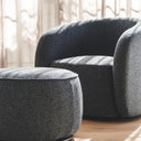 Nigella Ottoman in Comet Night Sky fabric with swivel base and piped edge, styled next to Emily Swivel Chair