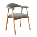 A upholstered dining chair with solid oak legs and a cushioned seat.