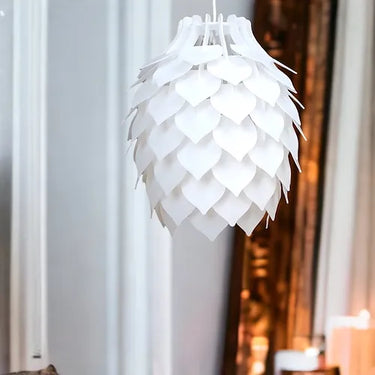 Pinopoly white pendant light hanging over a dining table in a modern interior