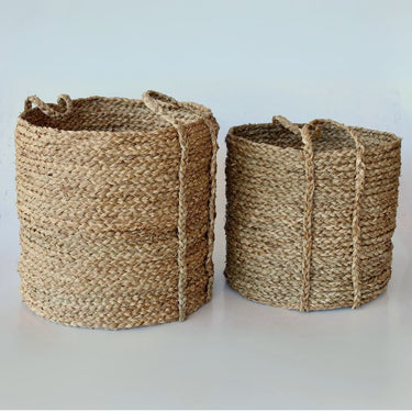 Round seagrass baskets in two sizes for versatile home decor.