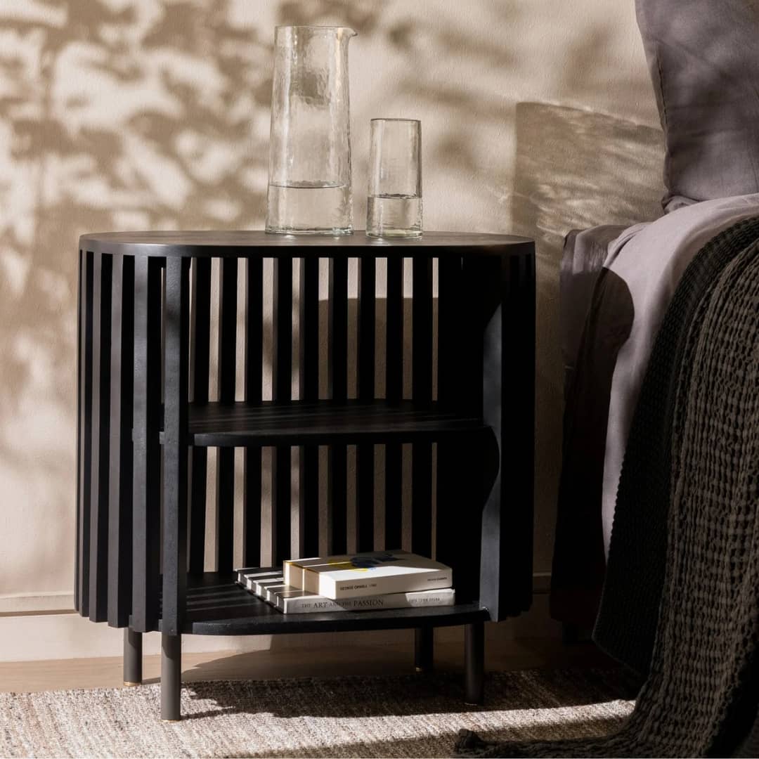 Swedish Nightstand in black, crafted from solid mango wood with elegant brass feet, in a stunning bedroom
available online at Woodka Interiors South Africa.