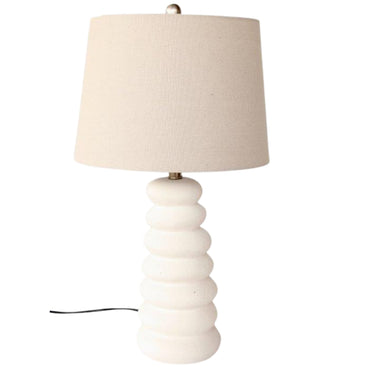 White ceramic table lamp with soft swirl base design and beige linen finial & harp shade