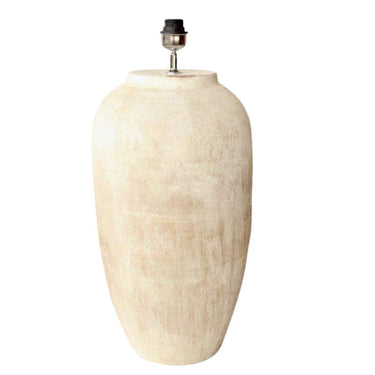 A large cement lamp base with a soft distressed terracotta and eggshell finish, showcasing its tactile texture.