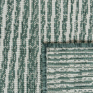 Close-up of polypropylene weave on the Tangram reversible geometric outdoor rug in hunter