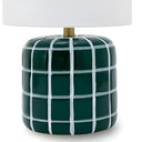 Green and white tartan-patterned ceramic lamp with a white shade.