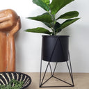 black planter on tripod stand