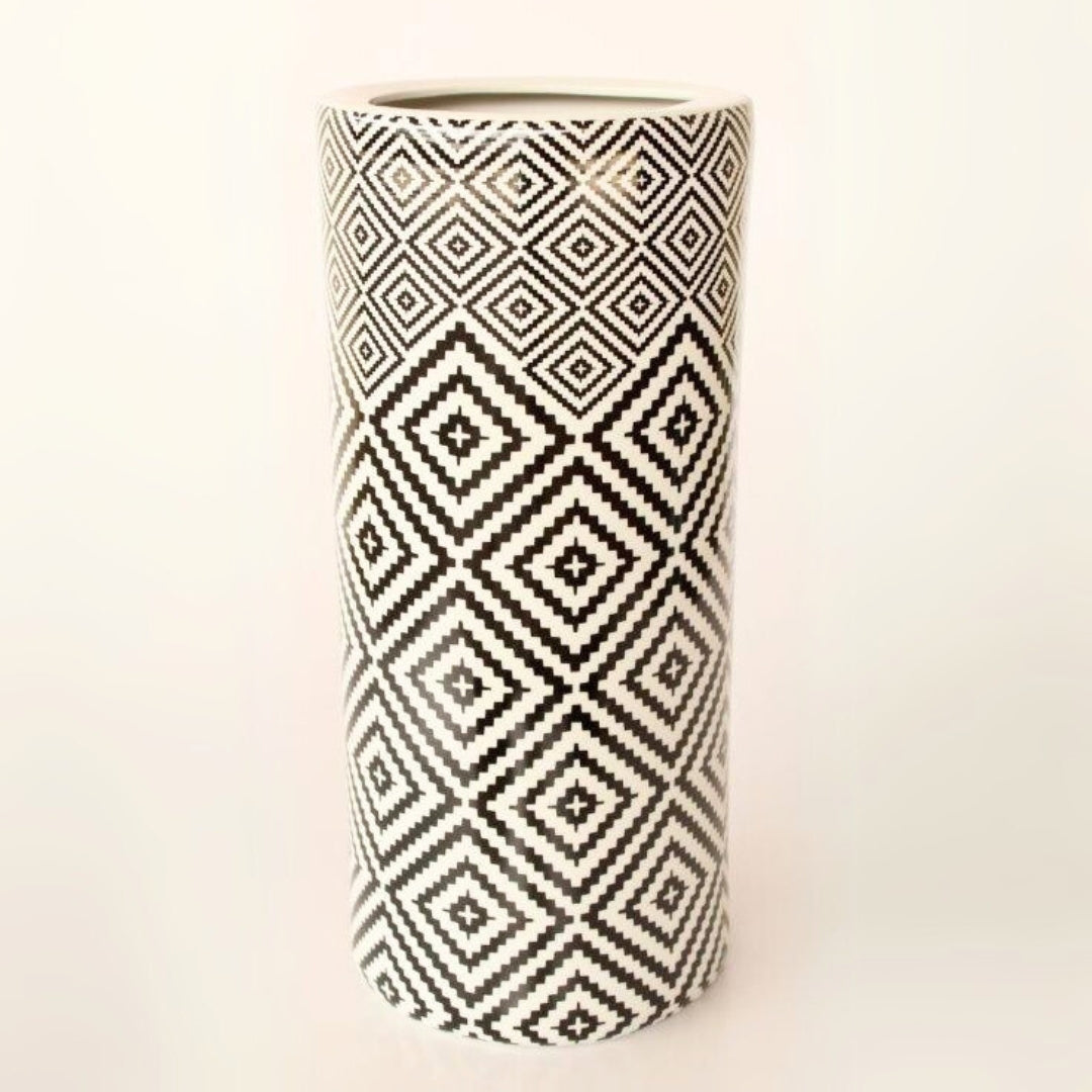 Geometric-patterned ceramic umbrella stand in black and white for versatile home decor.