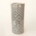 Geometric-patterned ceramic umbrella stand in black and white for versatile home decor.