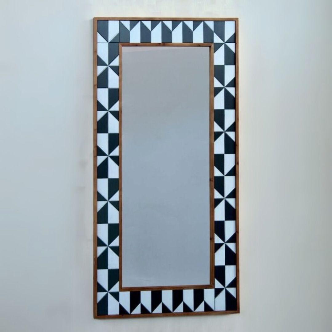 Rectangular wall mirror with a geometric frame.