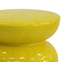 Bright yellow ceramic stool in a modern living room