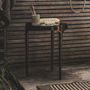 Bali Side Table holding décor – functional outdoor patio table styled outdoors.