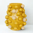 Ceramic vase with raised bobble texture and yellow finish