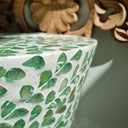 Stuning Green side table made with mother of pearl inlay styled infront of a wooden frame