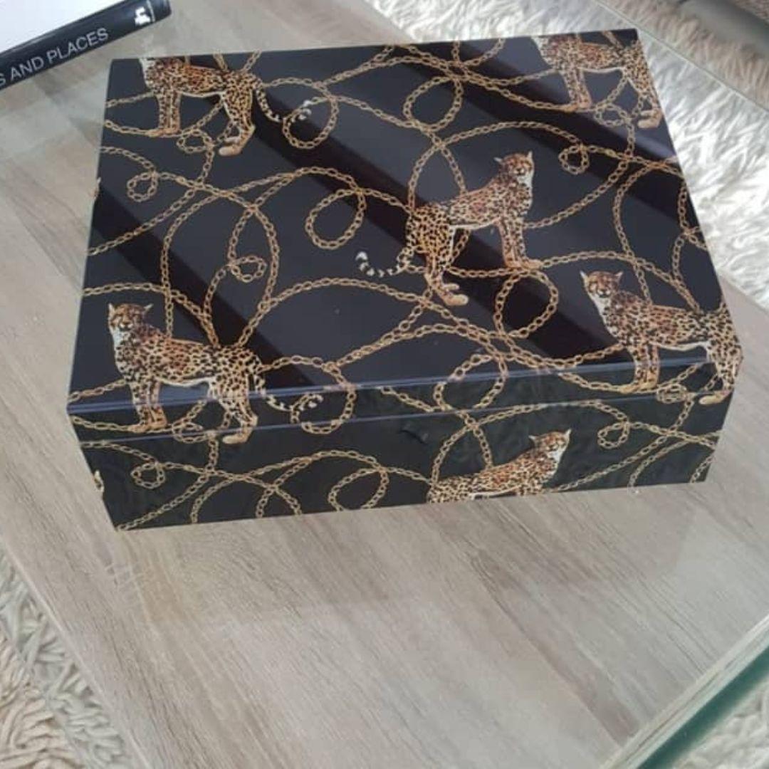 Decorative box with leopard pattern on a wooden surface