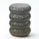 Grey ceramic side table with glossy finish and matte base detail. Sculptural side table for indoor or outdoor styling.