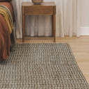 Large handwoven jute rug in rosemary tone in bedroom