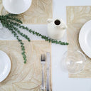 Table setting with Gold Leaf placemat, cutlery, and glassware