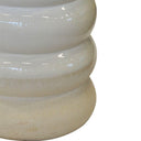 Close-up of a textured white stool on a white background