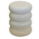 White ceramic stool with stacked ring design on a white background
