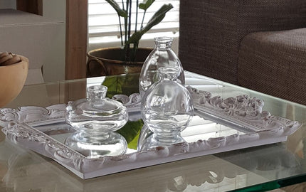Styled coffee table with tray, ornaments, and glass vases