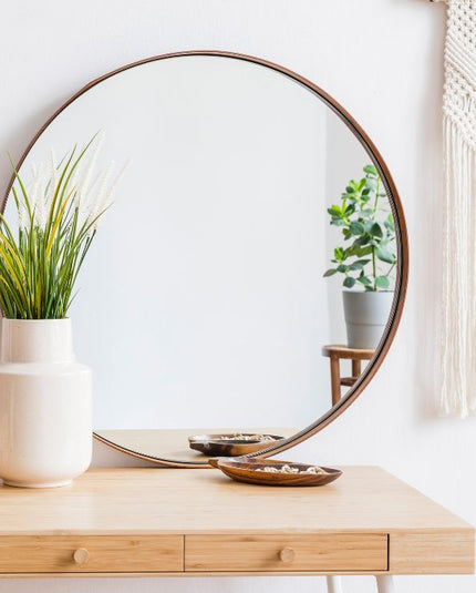 A brightened and balanced living space using strategic mirror placement ideas to maximize natural light and depth. 