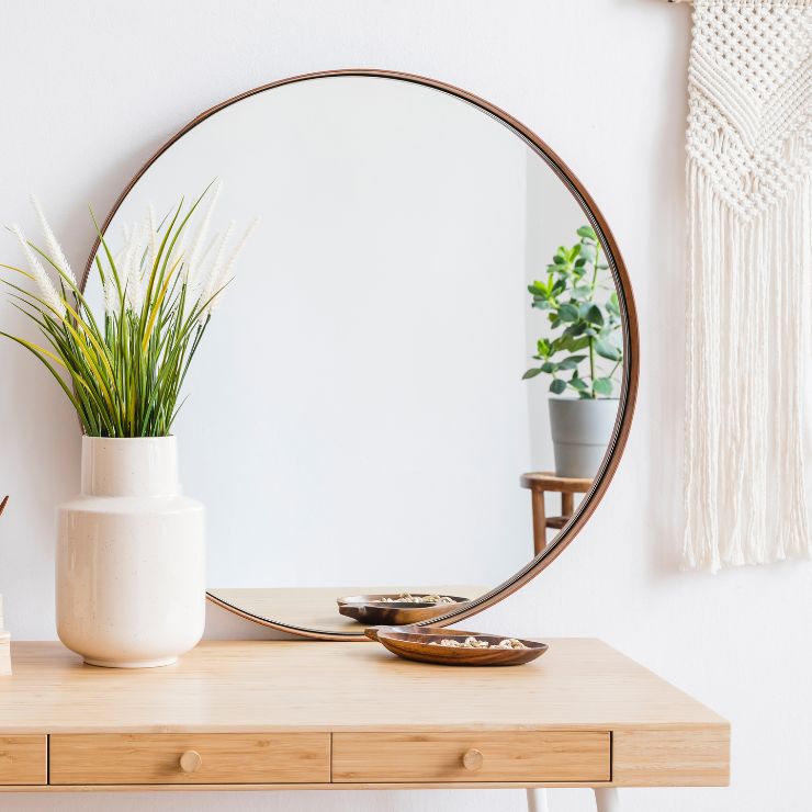 A brightened and balanced living space using strategic mirror placement ideas to maximize natural light and depth. 