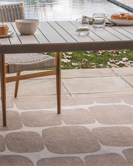 Durable, weather-resistant indoor-outdoor rugs in neutral tones by Woodka Interiors