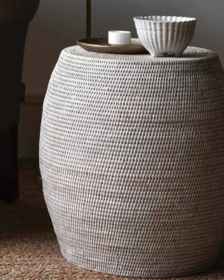 Elegant rattan stool placed in a cozy home setting, adding a natural, textured touch to the decor.