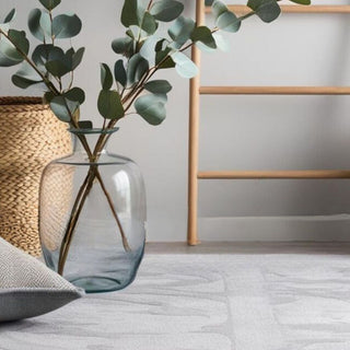 Home decor essentials including woven storage baskets, a decorative ladder, floor rug, and large artificial plants.