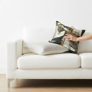 Scatter cushions by woodka interiors on a white couch in a living room