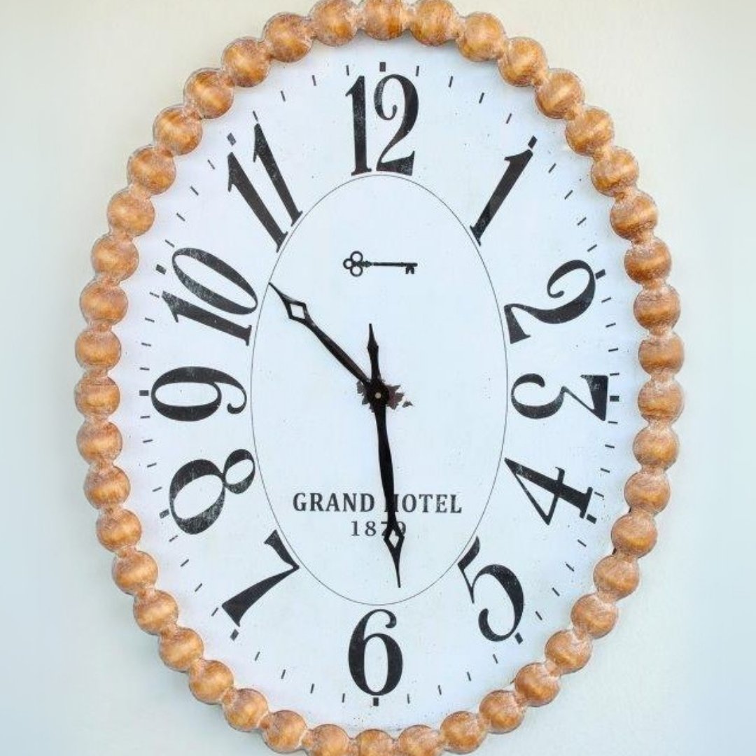 Large Oval Clock featuring a bobble-design wooden frame, perfect for stylish wall decor.